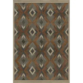 The Rowan Vinyl Rug is designed with a geometric pattern featuring earthy tones of brown, gray, and green. It showcases repetitive diamond motifs with inner triangles for a textured look and solid borders to frame the intricate design.