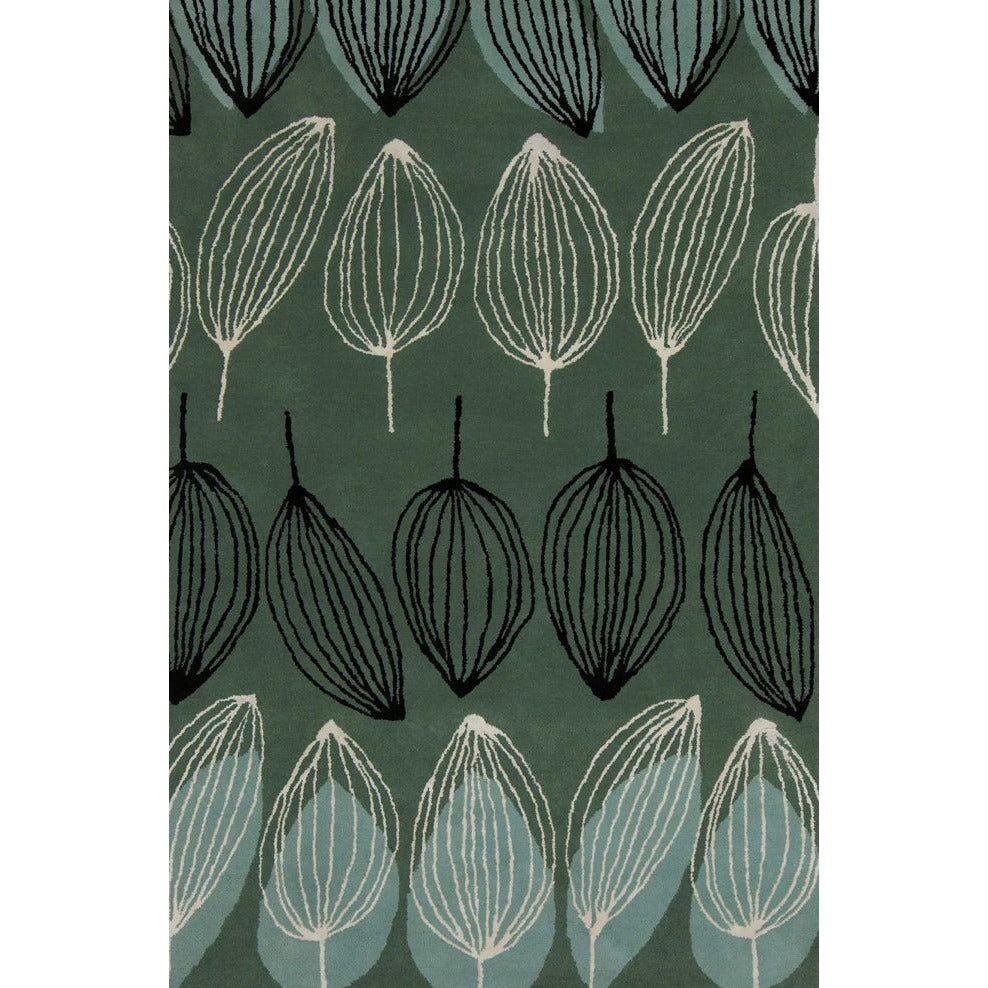The Zayana Rug features a modern botanical design with stylized black, white, and teal leaf outlines in horizontal rows on a muted green background.