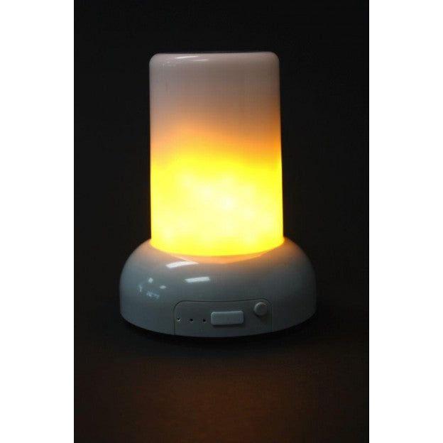 The Rechargeable LED Candle, a cylindrical lamp, emits a warm yellow light and is positioned against a dark background. Its white base features a small control panel with buttons and indicators for adjusting settings. The lamp appears to be battery-operated, boasting a smooth and modern design.
