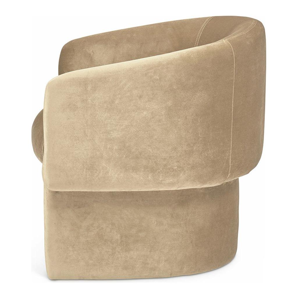 A plush, beige James Velvet Accent Chair with a soft, velvet-upholstered texture and rounded armrests, featuring visible stitching details. The chair has a circular base and a modern, compact silhouette.