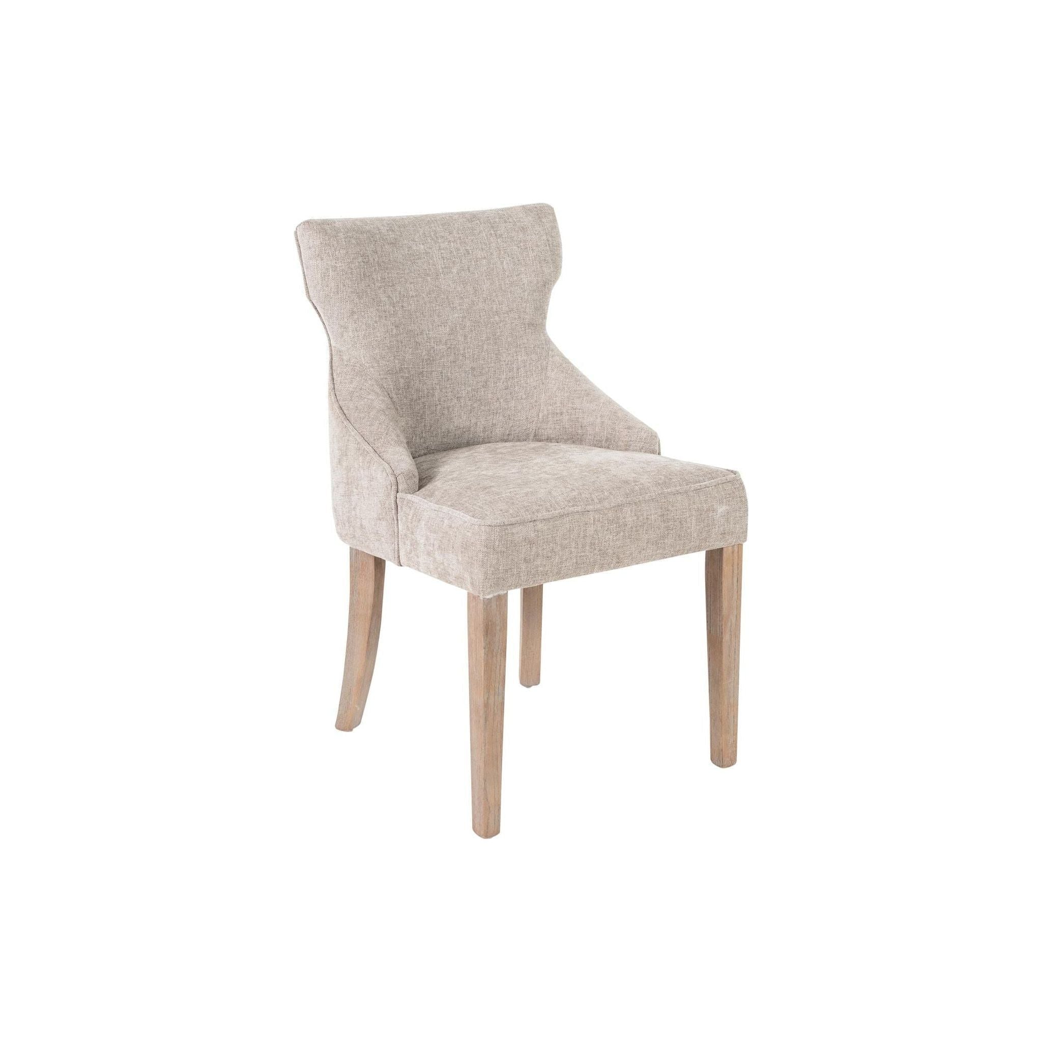 The Garet Dining Chair features beige upholstery with a cushioned seat and backrest. Its smooth, slightly curved back includes subtle wing-like extensions. With four wooden legs in reclaimed oak, this chair blends minimalist elegance with textured fabric for extra charm.