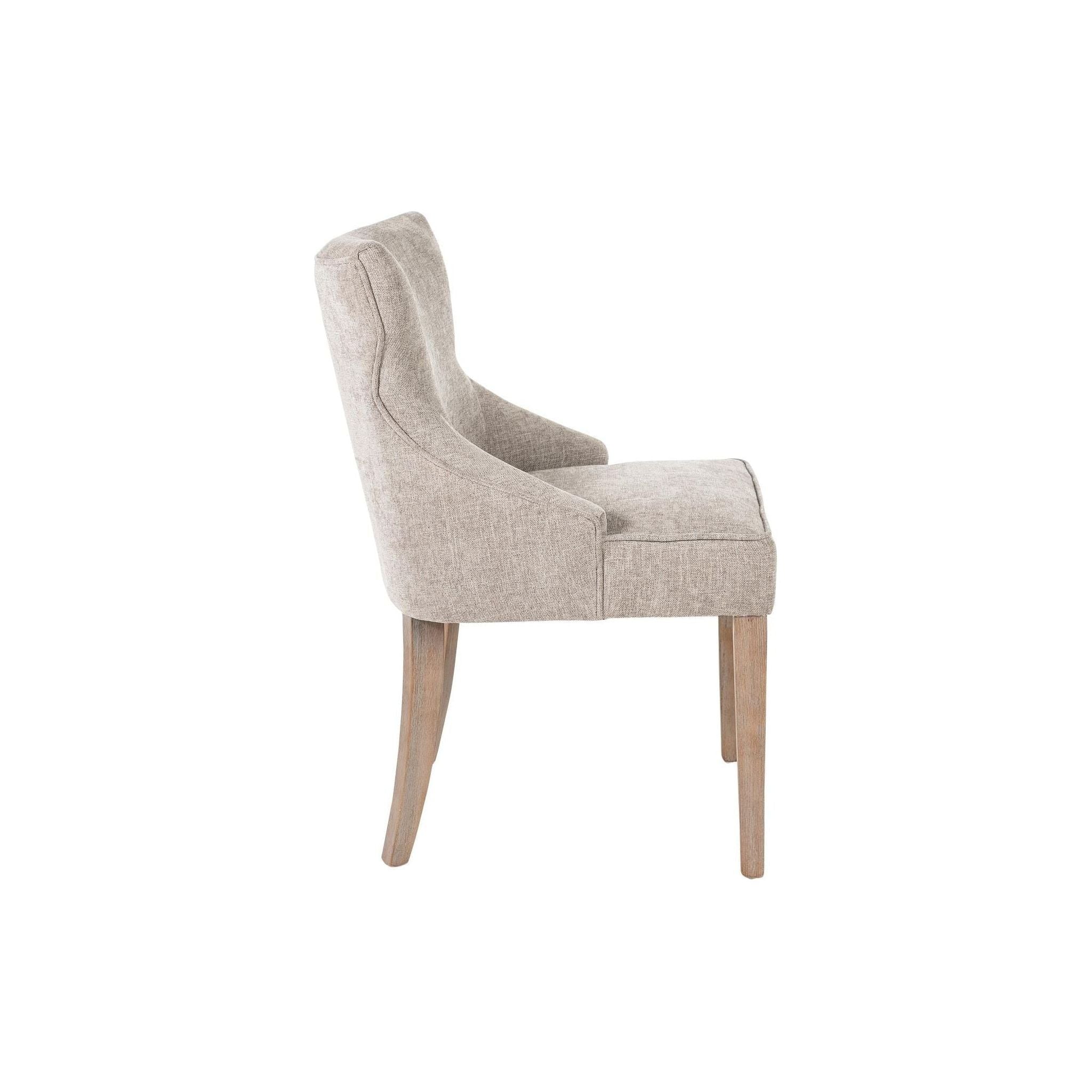 Side view of the Garet Dining Chair showcasing its gray upholstery. The chair boasts a curved backrest and a padded seat for added comfort. It is supported by four reclaimed oak legs finished in light brown. This design is both simple and elegant, making it suitable for modern or classic dining room decor.