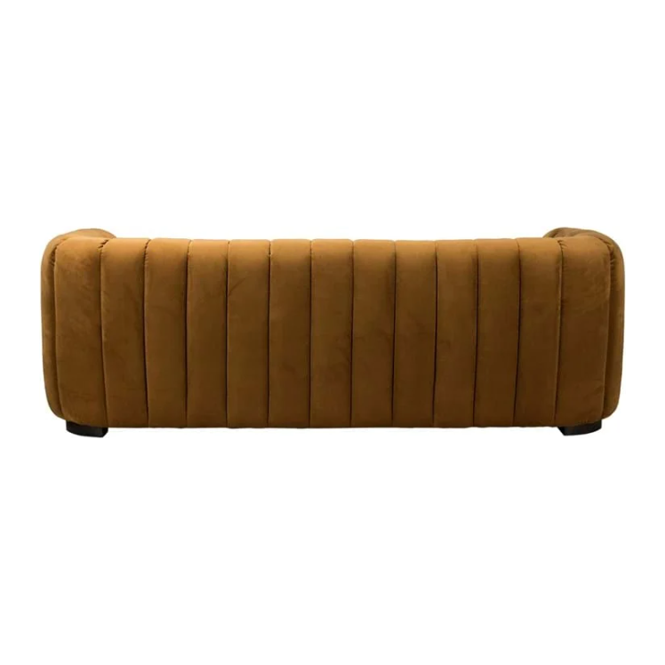 The Donna Upholstered Sofa features a modern back view with channel tufting in brown fabric, showcasing sculptural curves and vertical ribbed texture. It has rounded armrests and stands on short, dark wooden legs.