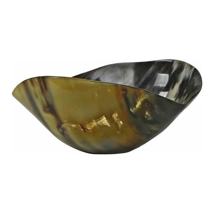 The Cow Horn Bowl is a polished, asymmetrical piece made from cow horns, featuring smooth, curved edges. The surface displays a marbled effect with earthy hues of brown, black, and tan. Its glossy finish accentuates the bowl's natural texture and unique shape, making it an ideal stylish natural accent.