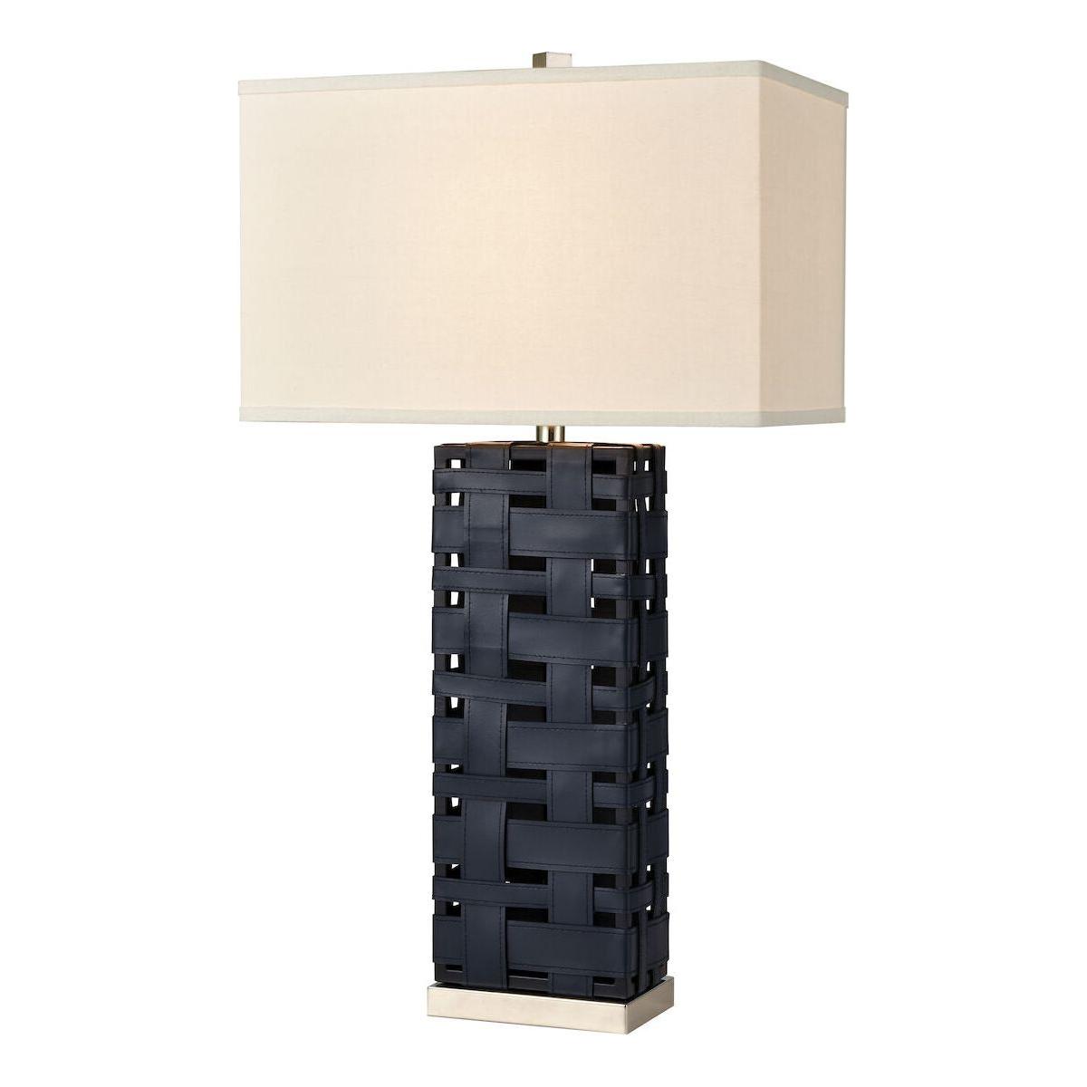 The Lattice Table Lamp features a modern design with a black woven leather base and a large rectangular white shade, set on a compact metallic platform, providing elegant lighting to any room.