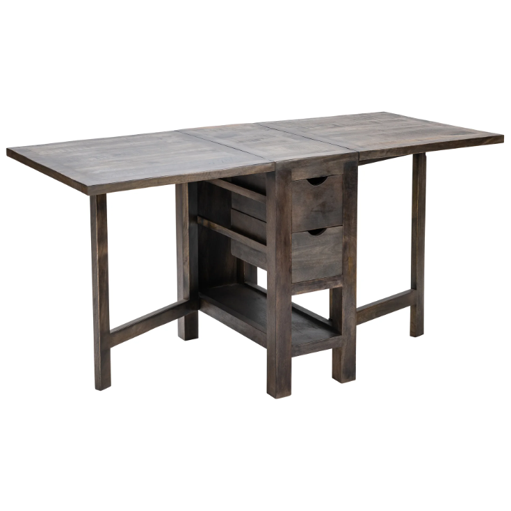 The Harold Folding Table is a wooden drop-leaf dining table with a rustic finish, ideal for small spaces. It features two foldable sides to extend the surface area, two storage drawers in the center, and a lower shelf. Supported by sturdy legs, this table boasts a functional, compact design perfect for any home.