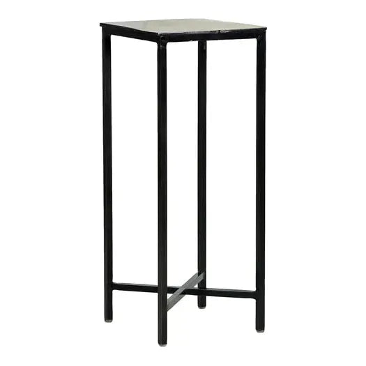 The Liora Martini Table is a tall, slender black metal stand with a square top and aluminum plating. It has four thin legs connected by horizontal supports, offering minimalist and industrial aesthetics similar to a vintage cocktail table—ideal for elevating plants or decor.