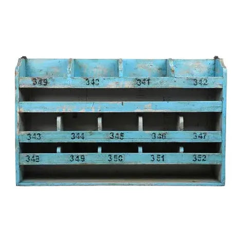 Introducing the Cubby Hole Hanging Shelf, a vintage piece crafted from blue wood, measuring 24½ inches wide and featuring multiple compartments. Its weathered structure bears signs of wear, adding character and charm to its appearance. Each compartment is labeled numerically in black, with numbers ranging from 345 to 352. The paint has been artistically chipped in places, revealing the aged wood beneath for a truly unique look.