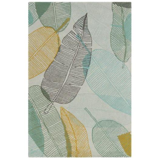 The Jessica Swift Wool Rug is a rectangular area rug adorned with a leaf pattern in shades of green, yellow, blue, and brown. The leaves overlap on a light beige background and feature thin, outlined designs with visible veins, creating a botanical and natural aesthetic.