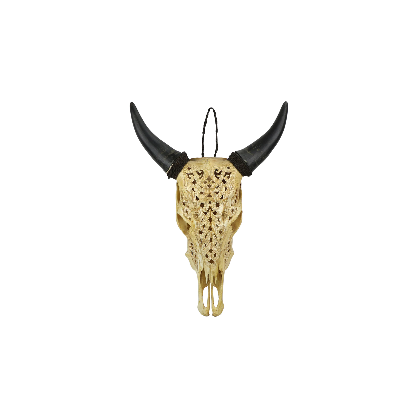 The Carved Lace Skull Wall Art is a handcrafted piece featuring black horns and intricate patterns on natural bone, suspended by a black cord against a white background.