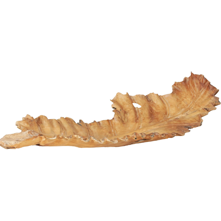 The Leaf Tray is a large, carved bowl made from teak wood, designed in an organic leaf-like shape with irregular edges and a natural wood grain texture. Its smooth surface showcases various shades of brown and tan, enhancing its rustic charm.