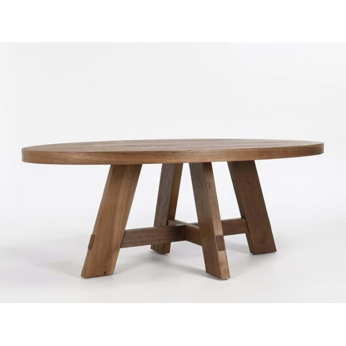 The Kael Oval Dining Table is a large, oval-shaped wooden dining table with a smooth, natural finish. Measuring 46D x 80W x 30H, it features sturdy, thick legs that form an A-frame design for a robust appearance. The legs are connected by crossbars for extra stability. The table has a minimalist and rustic look, set against a plain white background.