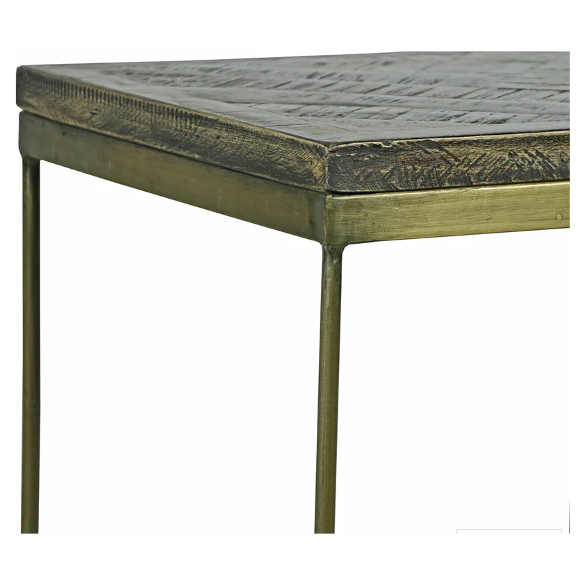 Close-up of the Parquette Side Table corner, showcasing a textured, dark-finished tabletop with a geometric mosaic pattern. Slim metal legs and an antique brass frame combine rustic and refined styles against a plain white background.