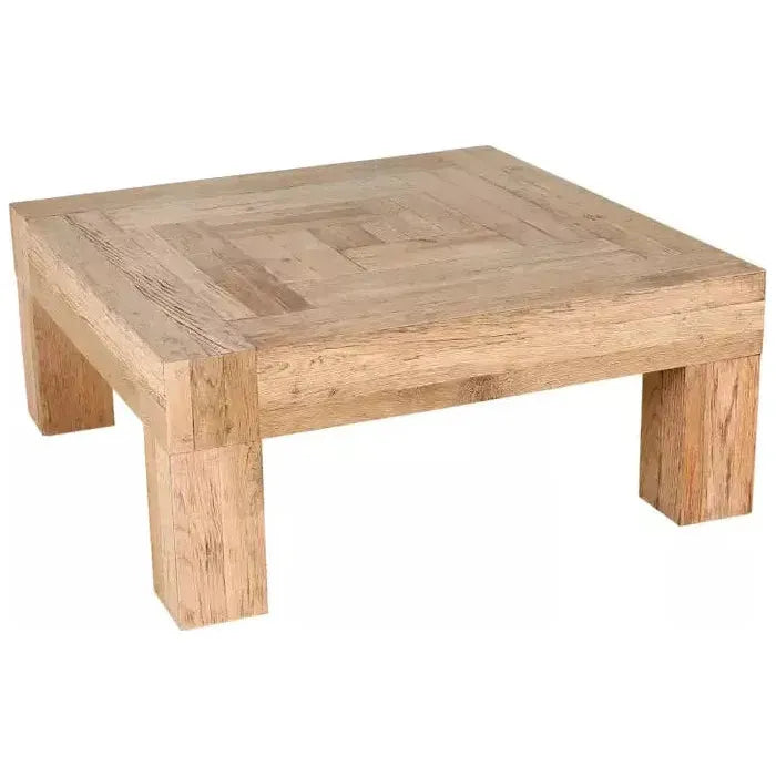 The Block Coffee Table, Natural is a square wooden table made from reclaimed oak. It features a parquet-style top and four sturdy block legs with a light, natural finish that highlights the wood's grain patterns, emphasizing its simple, rustic design and craftsmanship.