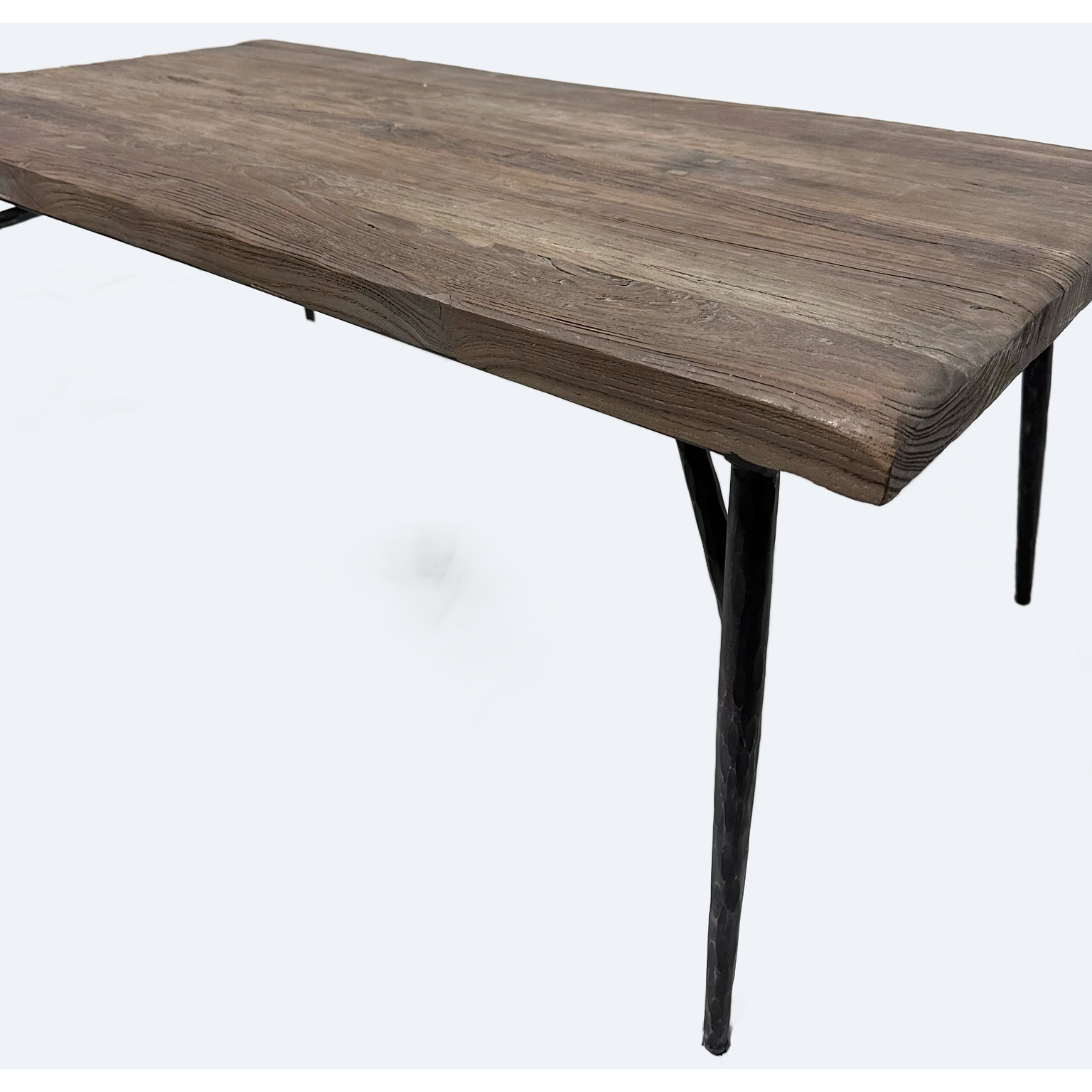 The Gretel Rustic Wood Coffee Table features a weathered brown reclaimed wood surface and four slim black metal legs. Its simple industrial design and textured wood grain stand out against the plain white background.
